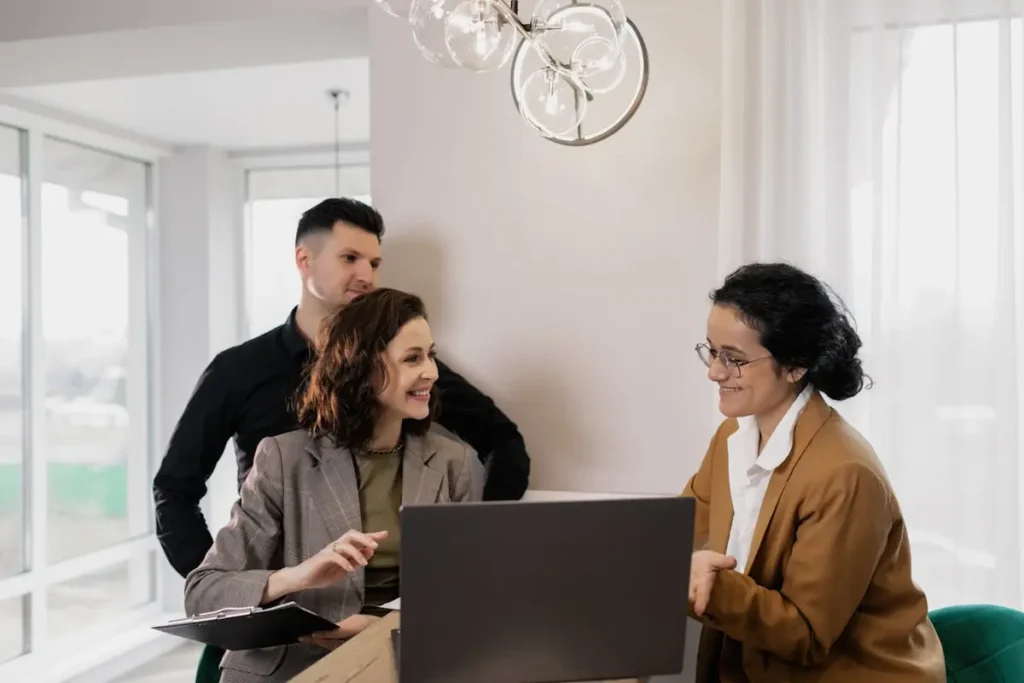 Man and woman talking with an agent in an office