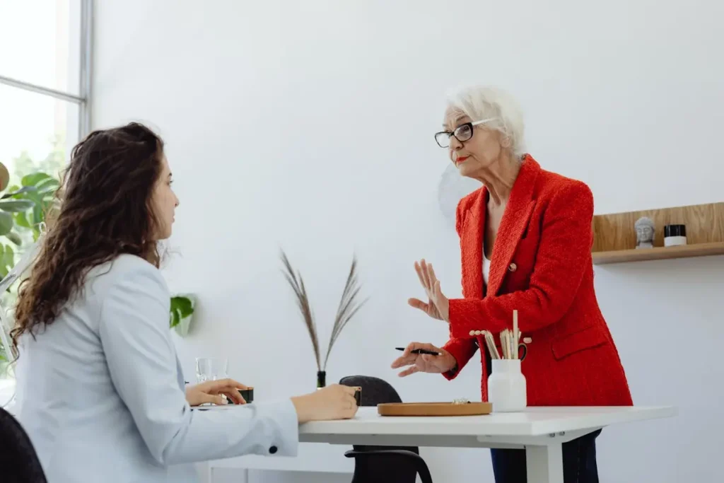 Two women in a modern office discussing HR support