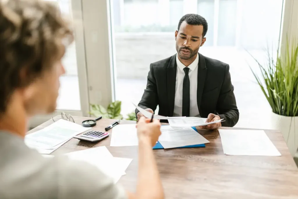 Man in suit holding documents while using Winslow HR chatbot