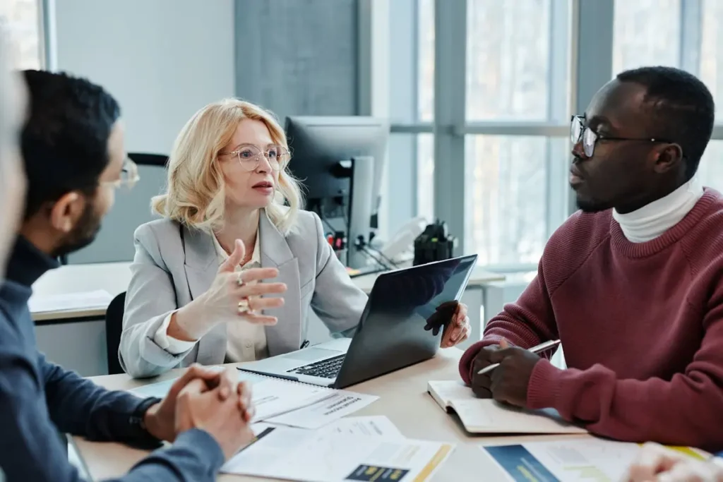 Woman in gray blazer using Winslow HR chatbot on laptop