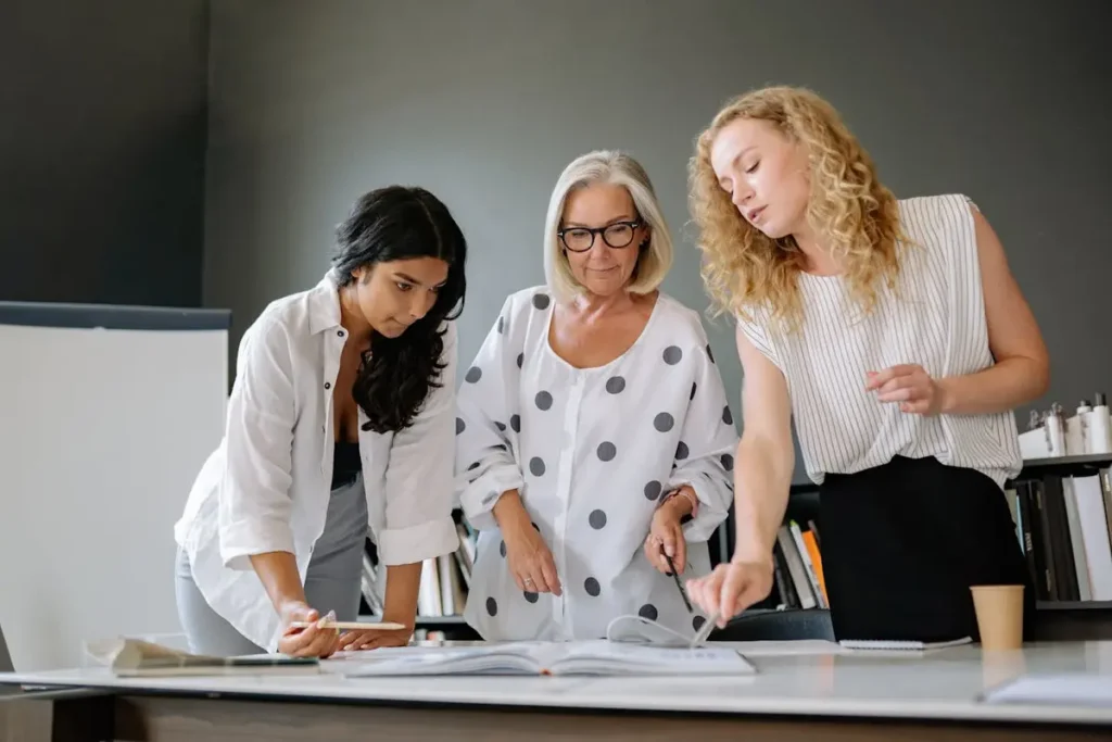 Colleagues reviewing paperwork together in an office